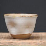 Pinch beaker, Matt white glaze on speckled clay